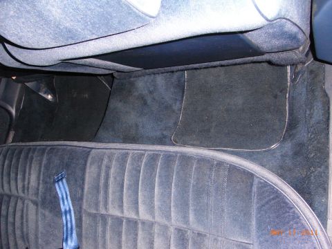 1991 Ford LTD Crown Victoria - Interior view of a car's rear seat and floor mats.