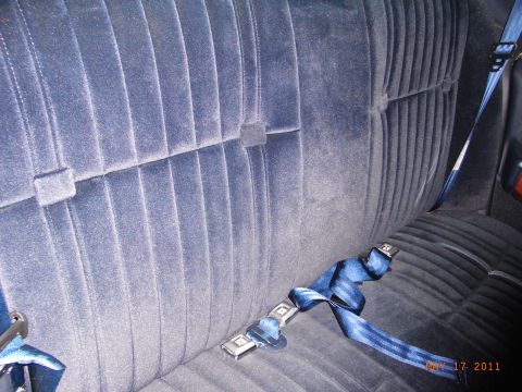 1991 Ford LTD Crown Victoria - Interior view of a blue velour bench seat with seatbelts.