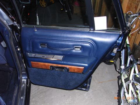 1991 Ford LTD Crown Victoria - The interior door panel of a vehicle is shown, with a bicycle visible through the open door.