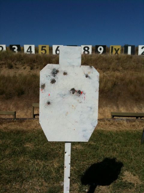 2013 Ford Mustang - A target stands in a field with numbered markers behind it, under a bright blue sky.