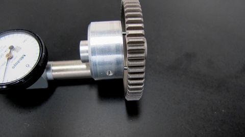 1996 Ford Bronco - Dial indicator tool measuring a gear on a dark surface.