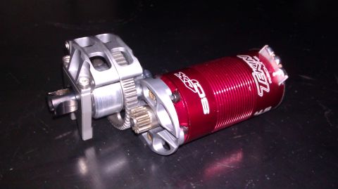 1996 Ford Bronco - Close-up of a red electric motor assembly with visible gears and silver metal housing.