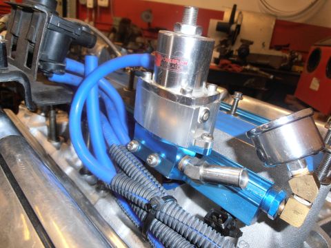 1990 Ford Bronco - Aftermarket fuel pressure regulator and fuel lines installed on an engine.