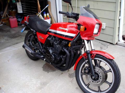 2008 Ford Crown Victoria - A red Kawasaki GPz 1100 motorcycle is parked in a garage, showing its front three-quarter view.
