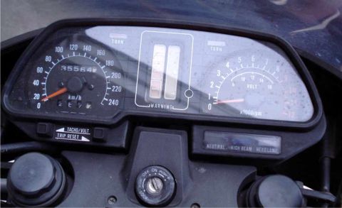 2008 Ford Crown Victoria - Close-up of a motorcycle's instrument cluster, showing the speedometer, tachometer, and various indicator lights.