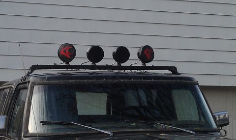 1979 Ford Bronco - KC lights mounted on a roof rack are visible on the top of a vehicle.