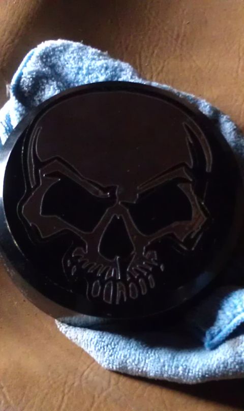1979 Ford Bronco - A close-up shows a black emblem with a skull design resting on a blue cloth.