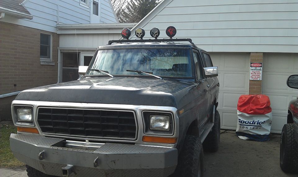 Dark blue 1978 Ford Bronco with aftermarket bumper and roof lights