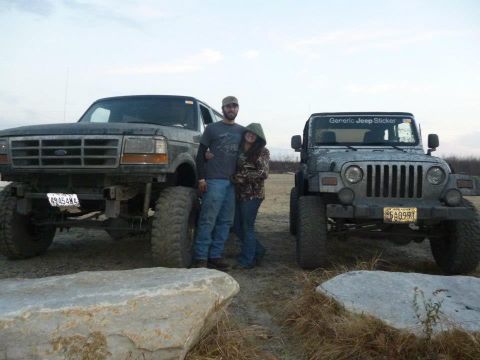 1995 Ford Bronco - A couple poses with their lifted Ford Bronco and Jeep Wrangler in an outdoor setting.