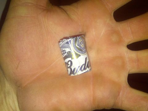 1995 Ford Bronco - A close-up of a Budweiser can tab resting in a person's hand.