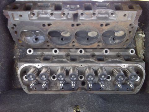 1995 Ford Bronco - Two engine cylinder heads are shown, one stacked on top of the other. Visible text includes 'W. MOON'.