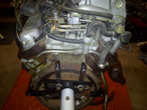 1995 Ford Bronco - Close-up view of an engine assembly, showing various hoses and fuel lines connected to the engine block.