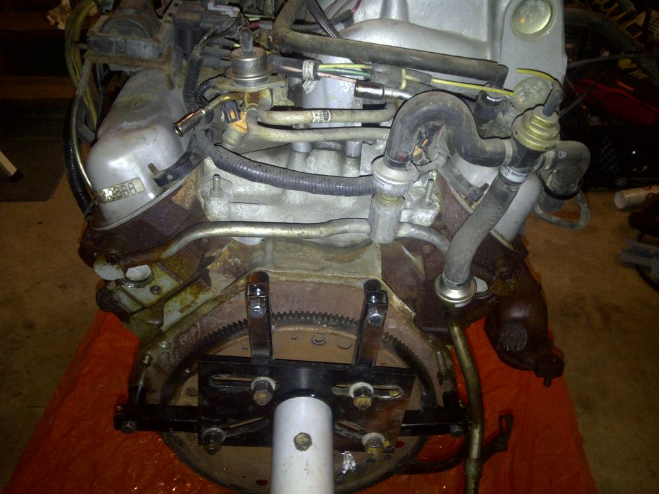 Engine assembly with fuel lines and hoses attached. A metal plate with '388A' is visible on the side