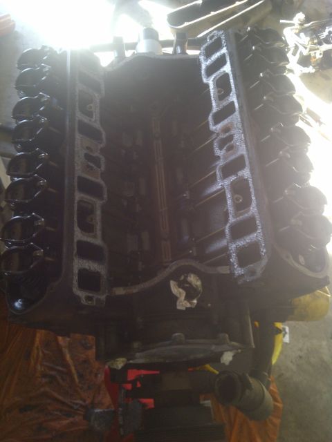 1995 Ford Bronco - Engine block with intake manifold ports visible, mounted on a stand for work.