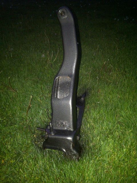 1995 Ford Bronco - A single automotive part is shown outdoors on a grassy surface. The part has some visible markings.
