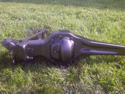 1995 Ford Bronco - A black rear axle assembly is shown resting on a grassy surface, with a SuperMotors.net watermark in the lower right corner.