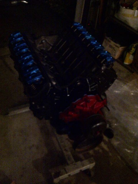 1995 Ford Bronco - Engine with blue valve covers and red intake manifold, likely a V8.