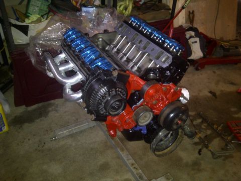 1995 Ford Bronco - Engine assembly with aftermarket performance parts, including headers and valve covers.