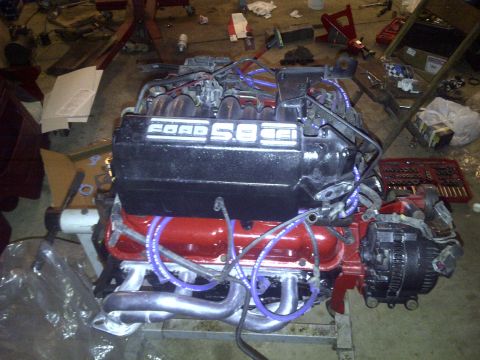 1995 Ford Bronco - A Ford 5.8L engine is shown on a stand, likely for a swap or rebuild.