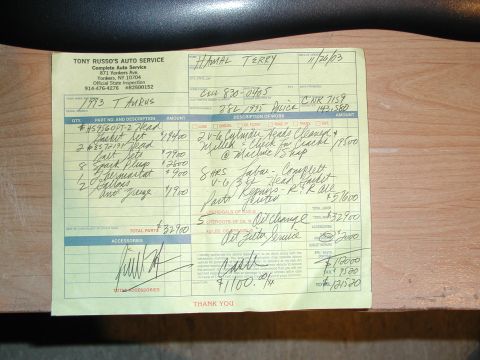 1993 Ford Taurus - A handwritten repair order from Tony Russo's Auto Service in Yonkers, NY dated 11/26/03 for a 1993 Taurus with 143,580 miles, listing head…