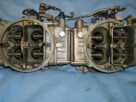 1971 Ford Ranchero - A pair of carburetors are shown from the top, with linkages and fuel lines attached.