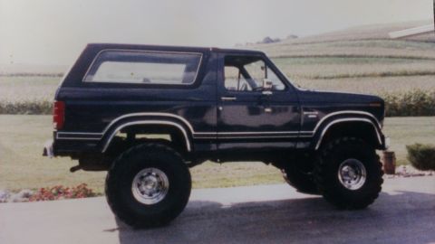 1995 Ford Bronco - This lifted Ford Bronco is shown from the side, large off-road tires.