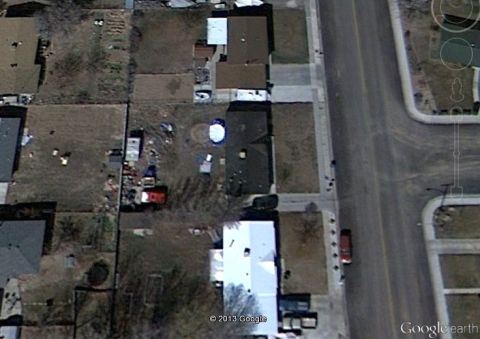 1979 Ford Bronco - Aerial view of a residential area showing houses and a red vehicle on the street.