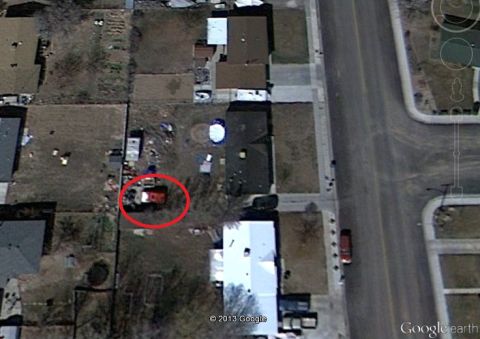 1979 Ford Bronco - An aerial view shows a red SUV parked in a residential yard.