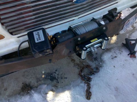 1979 Ford Bronco - A Tabor 12K winch is mounted to the front bumper of a 1979 Ford Bronco, partially obscuring the vehicle's grille.