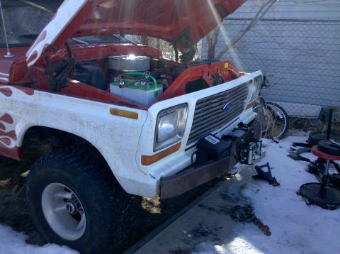 1979 Ford Bronco - This 1979 Ford Bronco features a winch mounted on the front bumper and its hood is open, revealing the engine compartment.