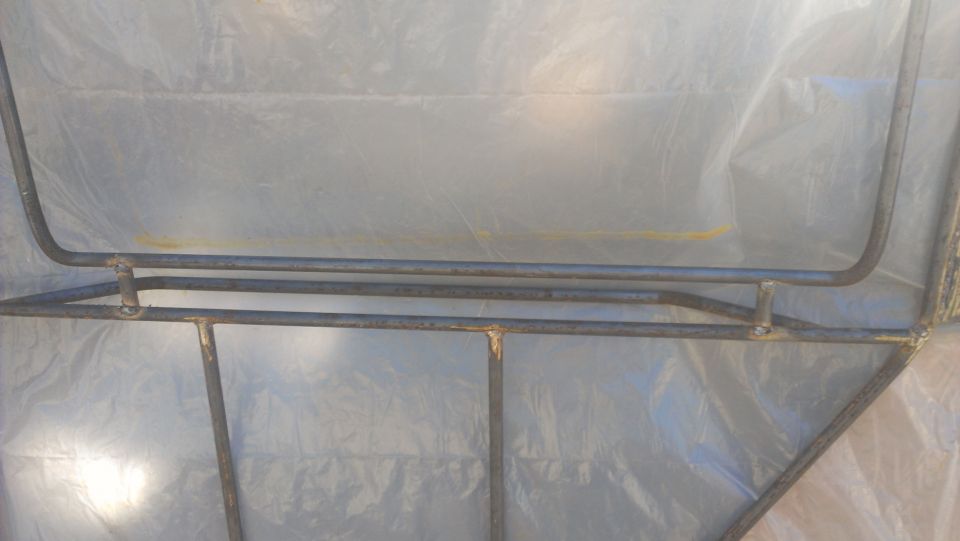 Roll cage structure against a plastic sheeting background
