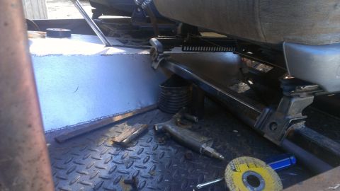 1978 Ford Bronco - Tools and seat hardware are visible inside a vehicle's interior, with a diamond plate floor and a Supermotors logo.