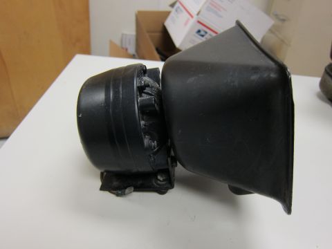 2001 Ford Crown Victoria - A black siren speaker is shown mounted on a surface, with a protective housing attached.