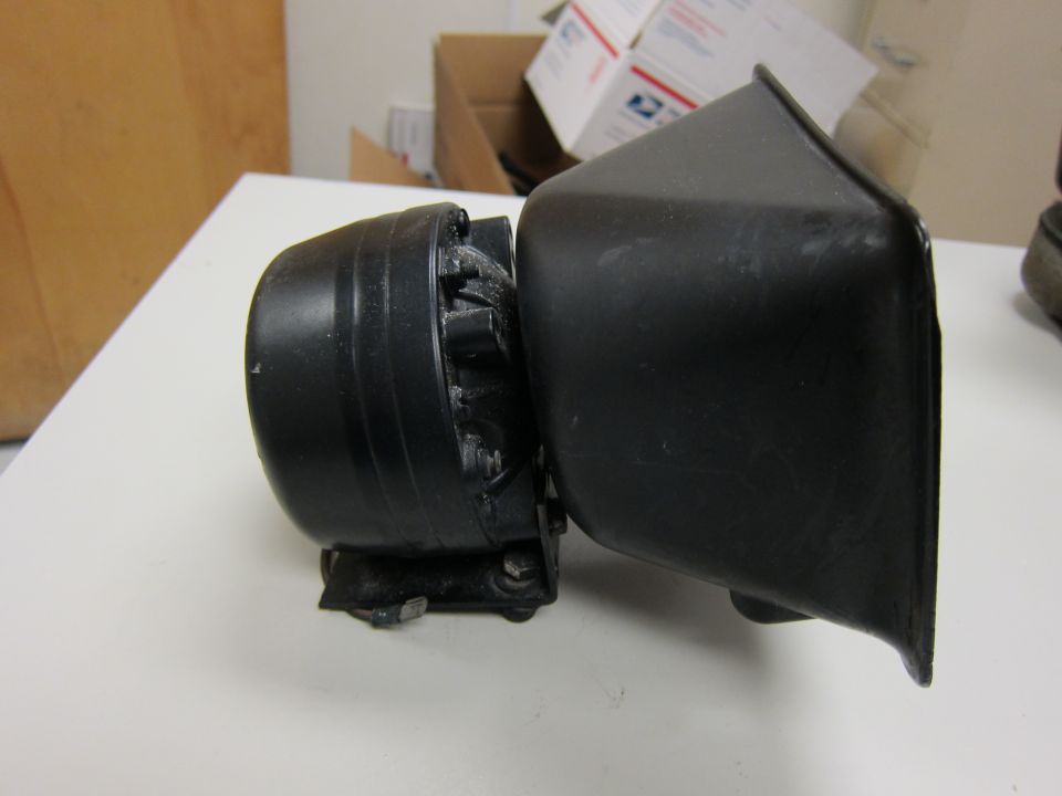 black siren speaker with a black housing attached