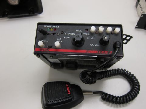 2001 Ford Crown Victoria - A Code 3 siren control unit and microphone are shown, likely from an emergency vehicle.