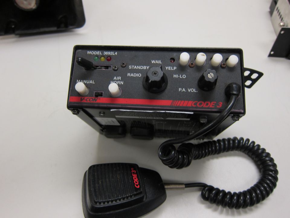 Code 3 siren control box with manual, air horn, standby, radio, wail, yelp, hi-lo, and pa vol. controls. Includes microphone