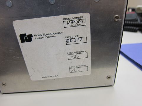 2001 Ford Crown Victoria - A label on a metal device shows manufacturer information and a date code.