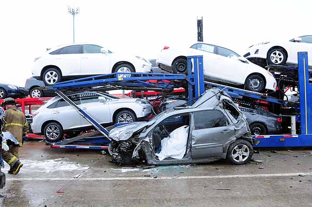 Wrecked silver SUV on car carrier, front view