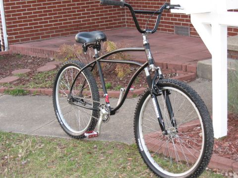 1994 Ford Bronco - A custom black bicycle with a unique frame design and off-road tires is shown from a three-quarter front view.