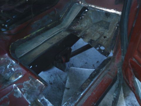 1978 Ford Bronco - Vehicle interior floor pan repair in progress, exposing structural components.