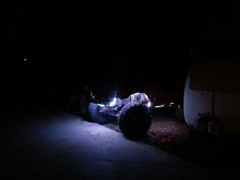 1978 Ford Bronco - An off-road vehicle is illuminated by its rock lights in the dark.
