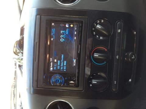 2008 Ford F-150 - Interior view of a vehicle's dashboard, showing the central console with a digital stereo and manual climate controls.