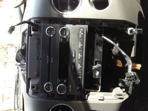 2008 Ford F-150 - The car's audio system is partially disassembled, revealing wiring and internal components.