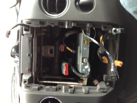 2008 Ford F-150 - The dashboard interior shows exposed wiring and electronic components within the radio cavity.