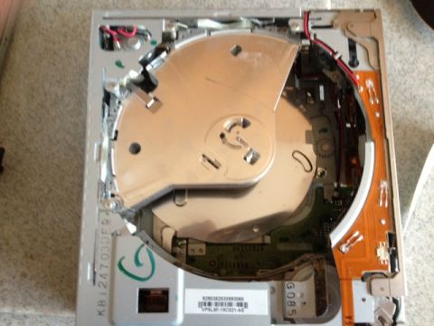 2008 Ford F-150 - The internal components of a car's CD player are visible, showing intricate wiring and mechanical parts.