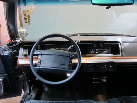 1991 Ford LTD Crown Victoria - The interior of a 1991 Ford Crown Victoria, a police-style spotlight and a "HAZZARD COUNTY PATROL" sticker visible on the windshield.