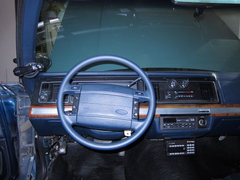 1991 Ford LTD Crown Victoria - Interior view of a 1991 Ford Crown Victoria LTD, showing the dashboard, steering wheel, and police radio.