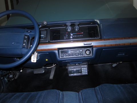 1991 Ford LTD Crown Victoria - The dashboard and interior of a car, a blue steering wheel and dark blue upholstery.