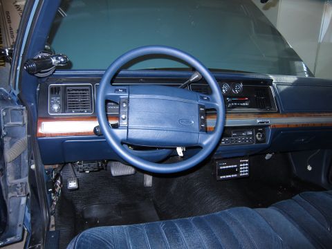 1991 Ford LTD Crown Victoria - The interior of a blue 1991 Ford Crown Victoria features a blue dashboard and steering wheel.