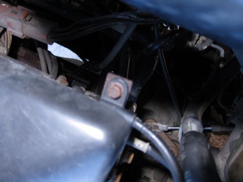1991 Ford LTD Crown Victoria - Detail shot of engine bay components, including hoses and electrical wiring.
